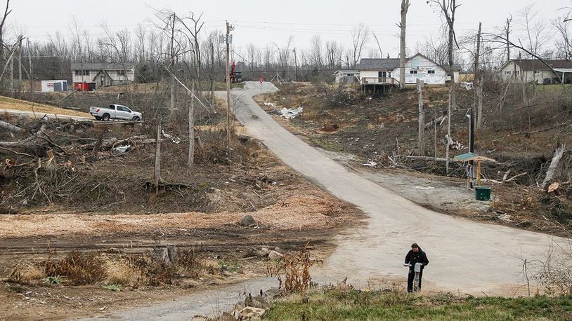 Aaron Krueger could barely see neighbors’ homes from his on Murwood Court in Beavercreek before the Memorial Day tornadoes swept through heavily wooded Grange View Acres. Now some of the homes are gone and others are in plain view. CHRIS STEWART / STAFF