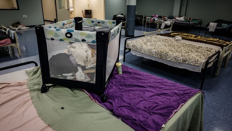 The family dormitory at St. Vincent De Paul shelter pushes beds together so mothers and children can be close. JIM NOELKER/STAFF