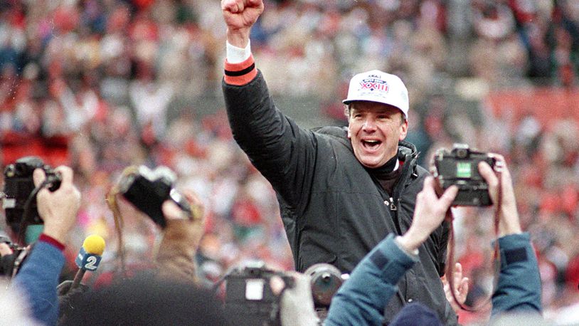 ** CORRECTS DATE TO JAN. 8, 1989, NOT JAN. 9, 1989 ** FILE ** Cincinnati Bengals coach Sam Wyche stabs the air as he is carried from the field on the shoulders of his players after their 21-10 victory over the Buffalo Bills for the AFC Championship game in Cincinnati , Ohio, in this Jan. 8, 1989 photo. A healthier, happy Sam Wyche is still in the game _ even if his to-do list at Pickens High includes things he never would have thought about in the NFL. Sweep out the locker rooms? You bet. Simplify his vast playbook for the high school game? Easily done. Watch his starting quarterback take a few days away from camp to play baseball? Not a problem. (AP Photo/Rob Burns)
