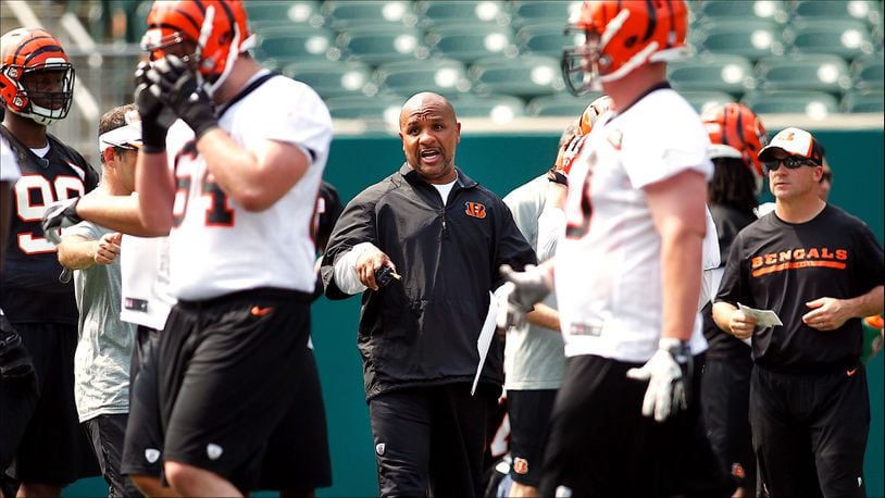 Cincinnati Bengals offensive coordinator Hue Jackson (center) works during Organized Team Activities at Paul Brown Stadium Tuesday, May 27, 2014, in Cincinnati. NICK DAGGY / STAFF