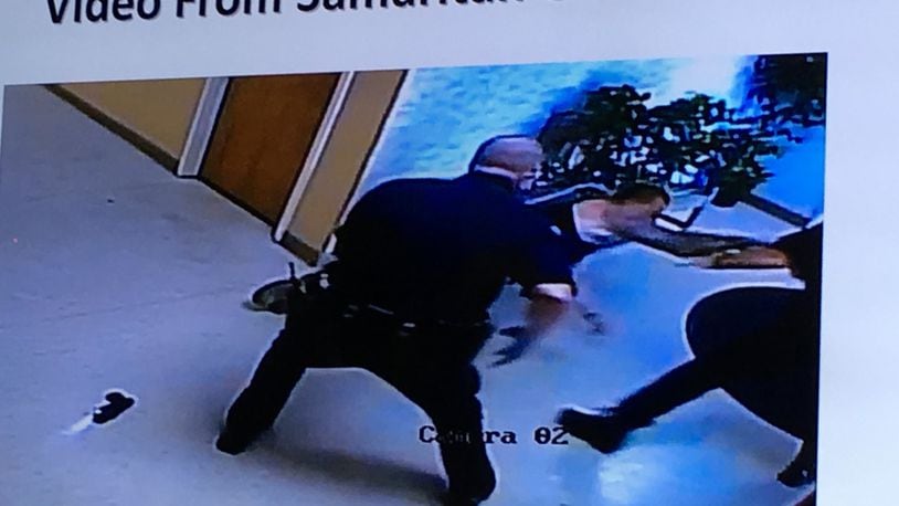 An image taken from surveillance footage shows Cory Fraley lunging toward a Dayton police officer on Sept. 3. Fraley was shot in the hip by an officer in the Samaritan Behavioral Health CrisisCare building.