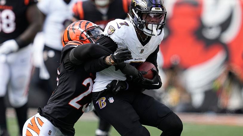 Baltimore Ravens wide receiver Rashod Bateman (7) is stopped by Cincinnati Bengals safety Dax Hill during the first half of an NFL football game Sunday, Sept. 17, 2023, in Cincinnati. (AP Photo/Darron Cummings)
