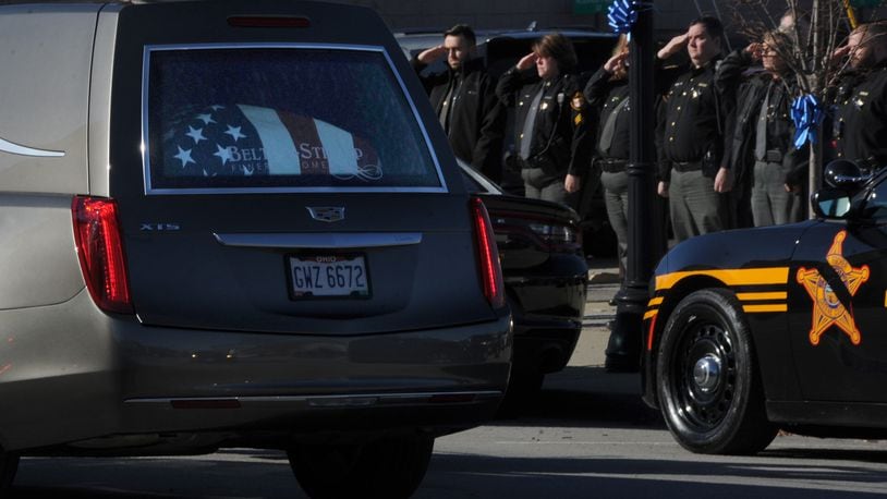 Greene County deputies salute as the procession for Sheriff Gene Fischer goes by the Sheriff's Office in Xenia Tuesday, Nov. 23, 2021. MARSHALL GORBY\STAFF