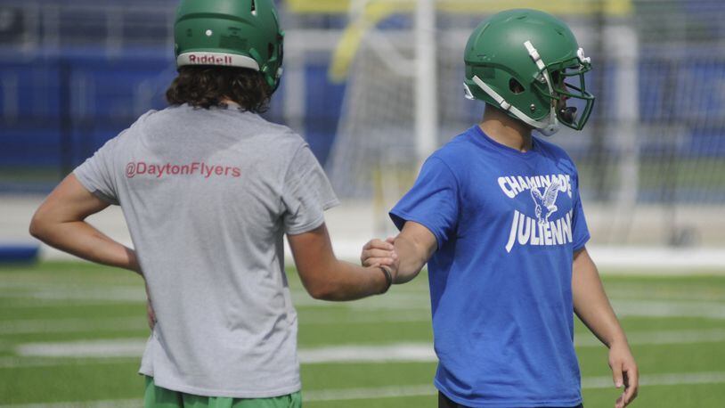 Noah Burneka (left) and Rocky Stark get defensive. Chaminade Julienne held its first day of preseason high school football practice on Monday, July 31, 2017. MARC PENDLETON / STAFF