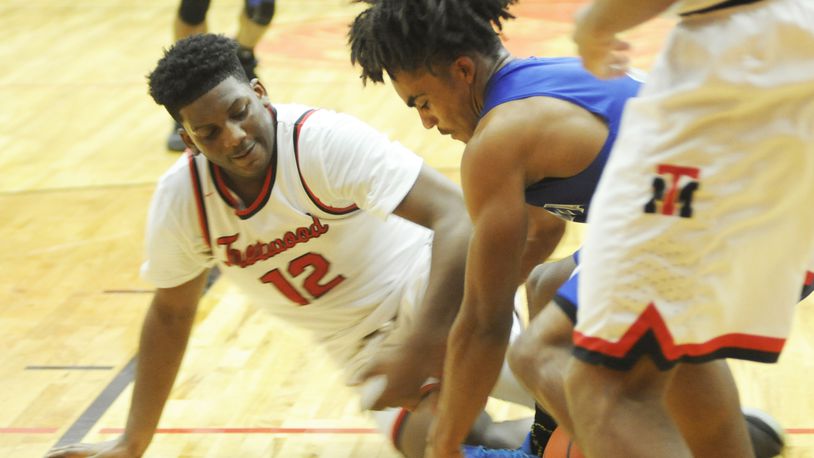 Trotwood’s Malachi Mathews (left) and Xenia’s Dylan Hoosier contend for a loose ball. Trotwood-Madison defeated visiting Xenia 95-60 in a boys high school basketball game on Friday, Dec. 14, 2018. MARC PENDLETON / STAFF