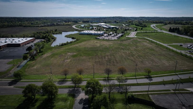 The Dayton Regional STEM School plans to buy more than 9 acres from the city of Kettering in Miami Valley Research Park to build a new elementary school. The existing STEM school building is at the left edge of the photo, with Woodman Drive at the bottom and the Research Park stretching away in the background. Jim Noelker/ Staff