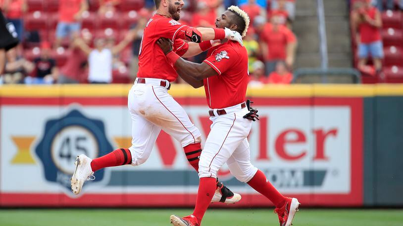 CINCINNATI, OHIO - JUNE 19: Jesse Winker #33 and Yasiel Puig #66 of the Cincinnati Reds celebrate after Winker hit a game winning RBI single in the 9th inning against the Houston Astros at Great American Ball Park on June 19, 2019 in Cincinnati, Ohio. (Photo by Andy Lyons/Getty Images)