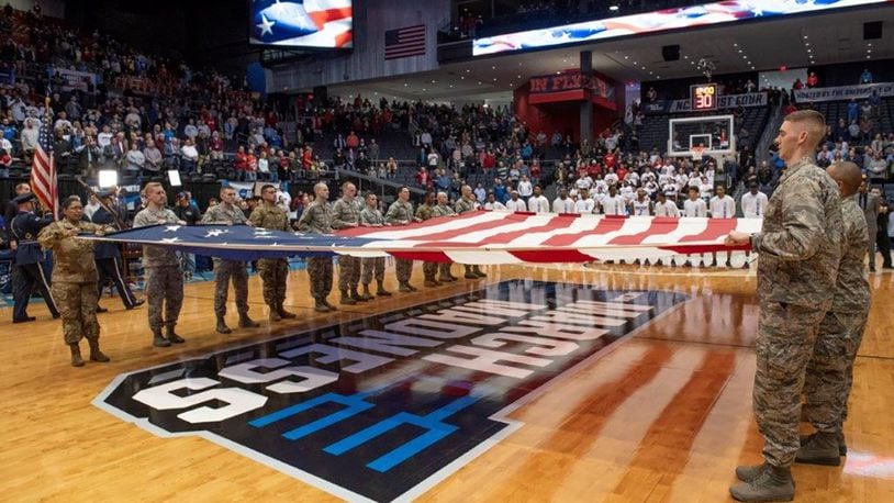 Airmen from Wright-Patterson Air Force Base hold a large garrison-size American flag during the presentation of the colors and singing of the national anthem at the NCAA First Four Tournament March 19 at the University of Dayton Arena. (U.S. Air Force photo/Michelle Gigante)