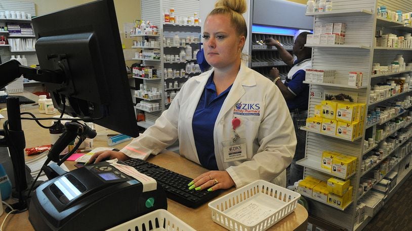 Desiree Mabe, a Pharmacy Tech at ZIKS Family Pharmacy, works on filling prescriptions, Tuesday July 27, 2021. MARSHALL GORBY\STAFF