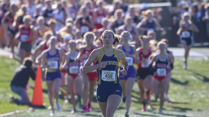 Cutline: Oakwood High School senior Grace Hartman leads the pack during the Division II girls race at the Ohio High School Athletic Association Cross Country Championships at Fortress Obetz. Hartman won the state championship for the second straight year. Michael Cooper/CONTRIBUTED