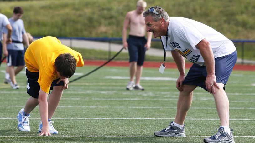 Monroe coach Brett Stubbs runs players through sprints during the first conditioning session of the summer on June 8, 2010, at Monroe. NICK GRAHAM/STAFF