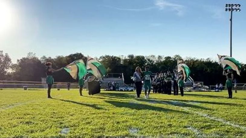 Members of the Bethel High School 2021 Homecoming Court walk past the marching band and color guard before the football game versus Lehman Catholic High School. The game and activities were delayed due to a threat that evacuated the stadium before the "all clear" was given.