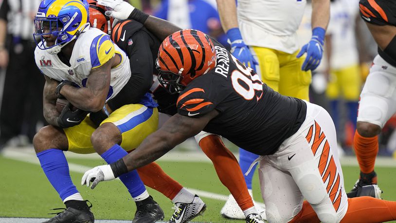 Los Angeles Rams running back Cam Akers, left, is tacked by Cincinnati Bengals strong safety Vonn Bell, middle, and nose tackle D.J. Reader during the first half of the NFL Super Bowl 56 football game Sunday, Feb. 13, 2022, in Inglewood, Calif. (AP Photo/Lynne Sladky)