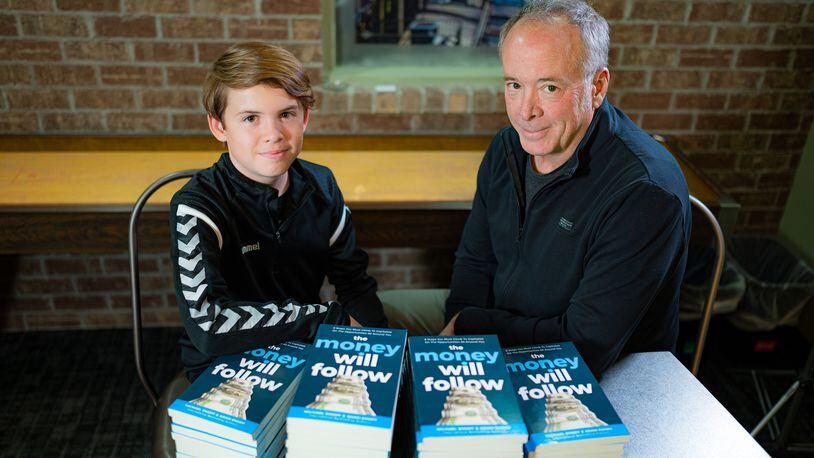 Adam Emoff, 14, is shown with his dad, Mike. The two have collaborated on a new book "The Money will Follow." Young Emoff is the author of more than 23 books. CONTRIBUTED