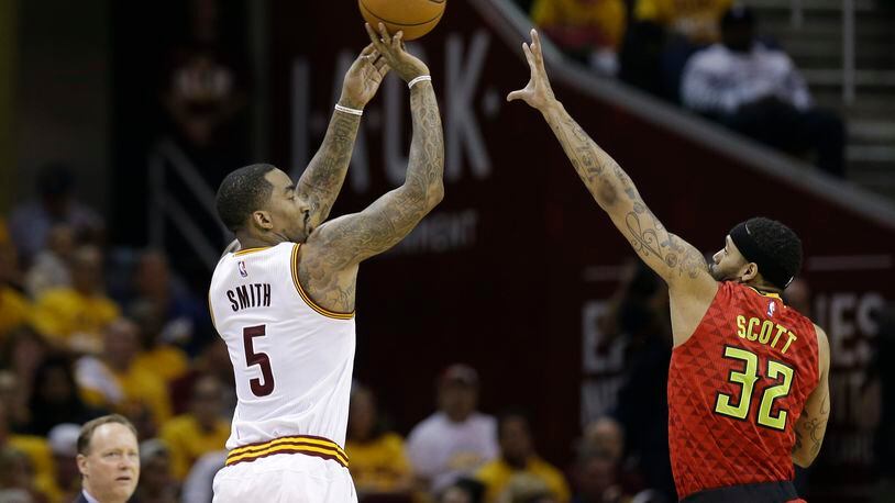 Cleveland Cavaliers guard J.R. Smith (5) puts up a 3-point shot against Atlanta Hawks forward Mike Scott (32) in the first half during Game 2 of a second-round NBA basketball playoff series, Wednesday, May 4, 2016, in Cleveland. (AP Photo/Tony Dejak)