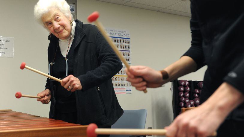 Sally Newman, 87, of Oakland plays the marimba during a new class at the University of Pittsburgh for people with mild cognitive impairment. (Nate Guidry/Pittsburgh Post-Gazette/TNS)