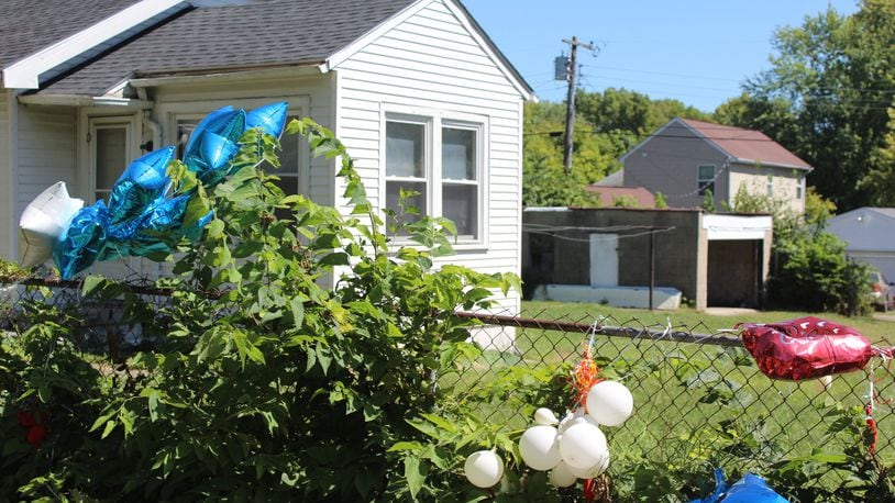 Balloons were hung on the fence outside of the home at 848 Conners St. by family and friends of the two teens who were shot and killed in a detached garage on Aug. 28. The home has since burned down as a resulted of suspected arson. CORNELIUS FROLIK / STAFF