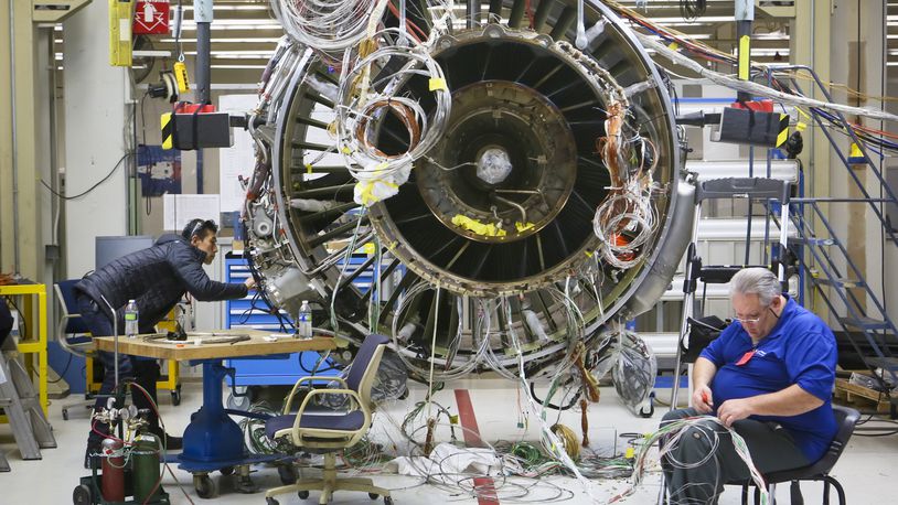 GE Aviation said Thursday Singapore Airlines has announced an order valued at $2 billion to the company. In this December 2014 photo, engineers work on a LEAP commercial jet test engine at GE Aviation in Evendale. GREG LYNCH / STAFF
