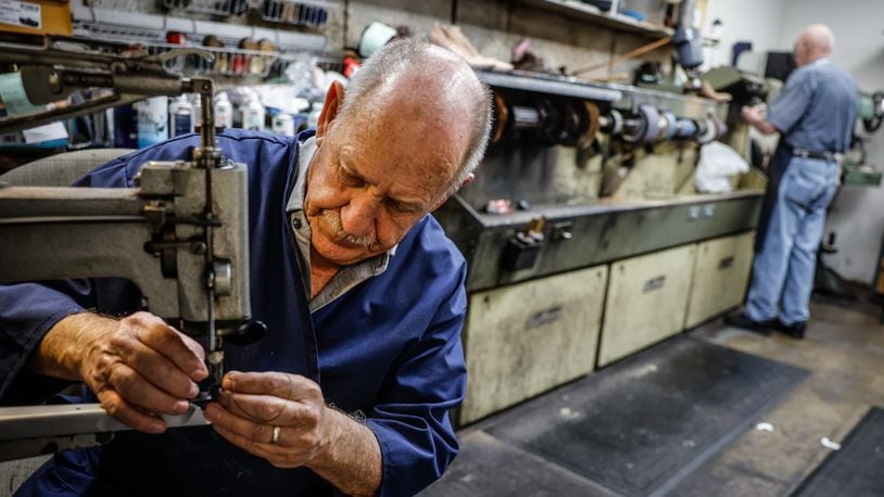 John Strehle works on a soccer shoe at his Kettering store on Woodman Drive. John and his wife, Joyce are closing their store, Strehle's Dry Cleaning & Shoe Repair after 50 of them owner of more than a seven decades old business. JIM NOELKER/STAFF