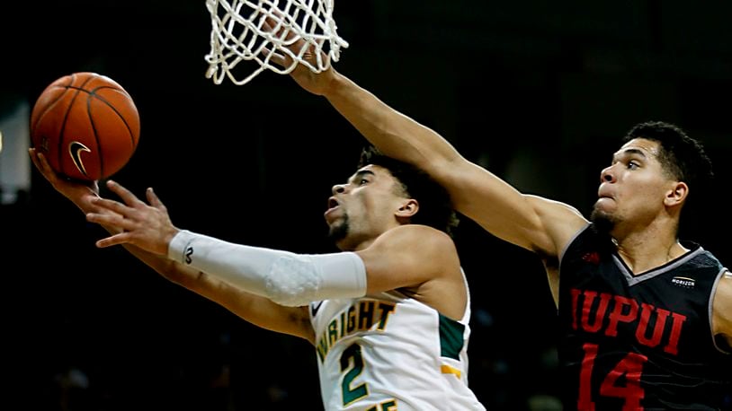 Wright State University guard Tanner Holden tries to score against IUPUI guard Marcus Burk during their Horizon League game at the Nutter Center in Fairborn Sunday, Feb. 16, 2020. Wright State won 106-66. Contributed photo by E.L. Hubbard