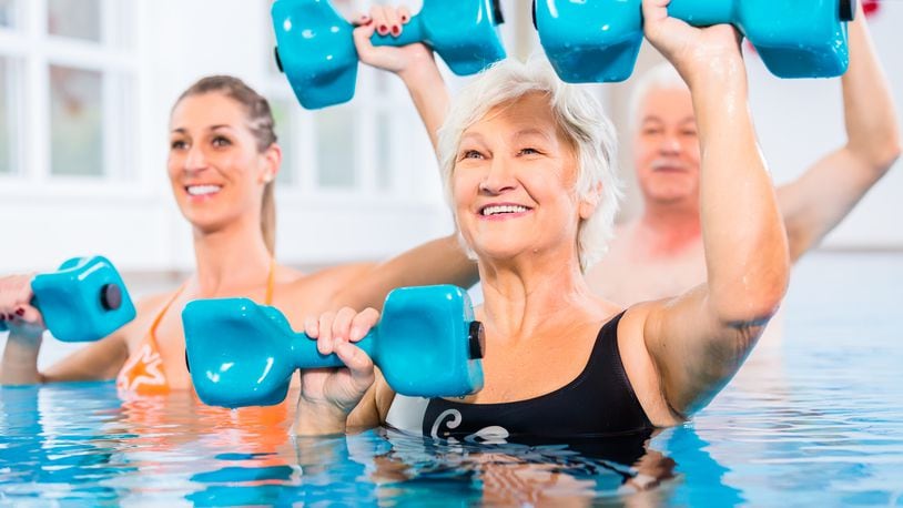 Water weights are foam barbells that create resistance under water. Start with the arms at the sides. Grip the bars of the water weights with the palms facing up. Raise the forearms to the level of the water, keeping the elbows close to the body and the wrists straight. iSTOCK/COX