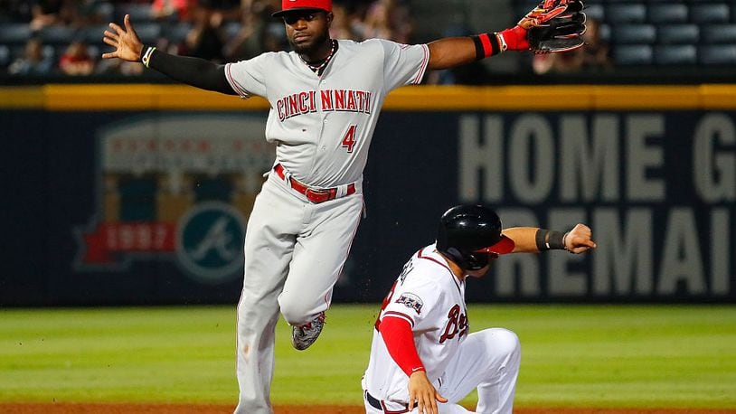 ATLANTA, GA - JUNE 14: Brandon Phillips #4 of the Cincinnati Reds reacts after turning a double play over Jace Peterson #8 of the Atlanta Braves to end the ninth inning and take a 3-1 victory at Turner Field on June 14, 2016 in Atlanta, Georgia. (Photo by Kevin C. Cox/Getty Images)
