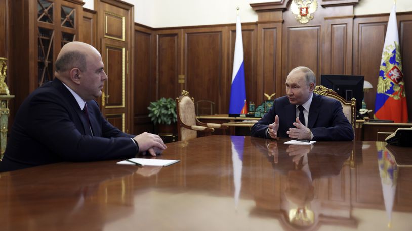 Russian President Vladimir Putin, right, speaks to Mikhail Mishustin, the candidate for the post of Russian Prime Minister during their meeting at the Kremlin in Moscow, Russia, Friday, May 10, 2024. (Gavriil Grigorov, Sputnik, Kremlin Pool Photo via AP)