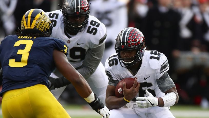 ANN ARBOR, MI - NOVEMBER 25: J.T. Barrett #16 of the Ohio State Buckeyes looks to run the ball first half against the Michigan Wolverines on November 25, 2017 at Michigan Stadium in Ann Arbor, Michigan. (Photo by Gregory Shamus/Getty Images)