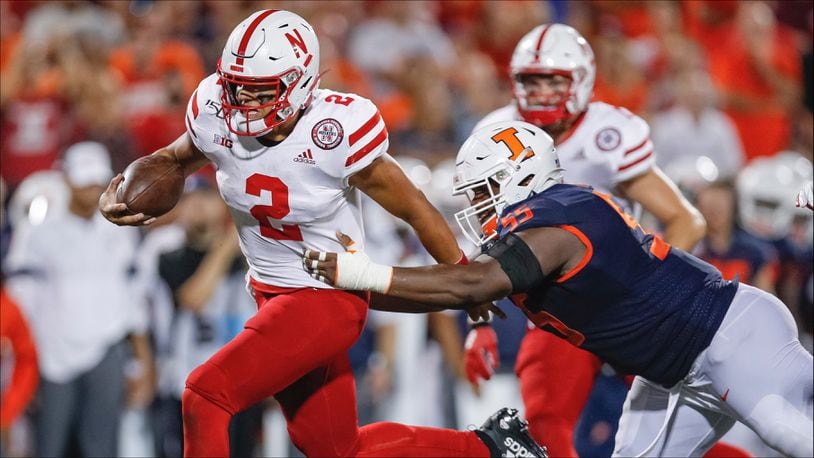 CHAMPAIGN, IL - SEPTEMBER 21: Adrian Martinez #2 of the Nebraska Cornhuskers runs the ball as Jamal Milan #55 of the Illinois Fighting Illini tries to make the stop during the second half at Memorial Stadium on September 21, 2019 in Champaign, Illinois. (Photo by Michael Hickey/Getty Images)