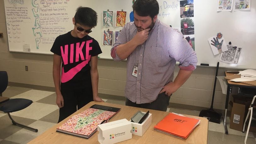 Lucas Boonchaliew, a seventh-grader, and Mad River Middle School visual arts teacher Jared Case test the new glasses Case helped make available to help correct Boonchaliew’s color blindness. CONTRIBUTED