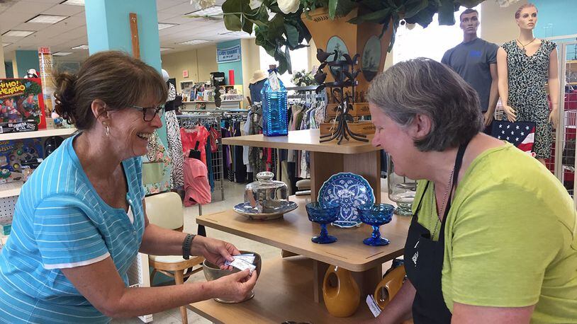 Officers’ Spouses’ Club volunteers Caroline Bunch (left) and De McMurry prepare a display of home decor items in preparation for the Wright-Patterson Air Force Base thrift shop’s Aug. 16 reopening. (Skywrighter photo/Amy Rollins)