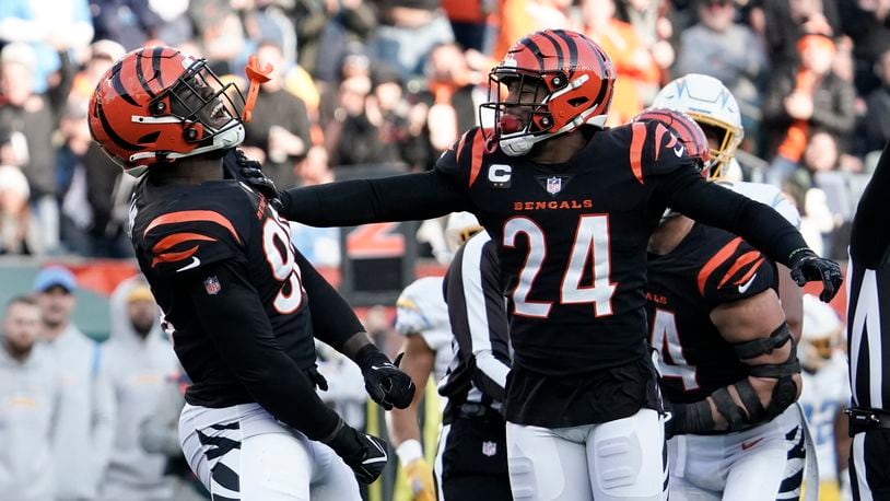 Cincinnati Bengals' Cameron Sample (96) and Vonn Bell (24) celebrate a sack of Los Angeles Chargers' Justin Herbert during the second half of an NFL football game, Sunday, Dec. 5, 2021, in Cincinnati. (AP Photo/Jeff Dean)