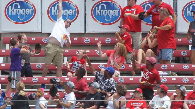 A fan tries to catch a home run hit by the Dodgers. David Jablonski/Staff