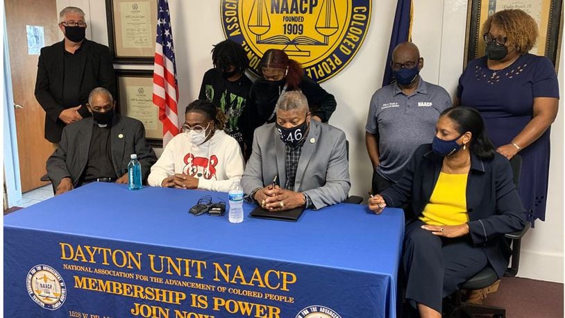 Clifford Owensby Sr., second from left, appears at a press conference Sunday with officials of the NAACP Dayton Unit to tell his side of an incident in which he was forcibly removed from his vehicle during a Sept. 30 traffic stop for an alleged window tint violation. Owensby is a paraplegic and could not step out of the vehicle as police ordered. At the table from left are the Rev. David Fox, Owensby, Derrick Foward, NAACP Dayton unit president, and Mattie P. White, first vice president of NAACP Dayton Unit. The incident remains under investigation by police. ED RICHTER/STAFF