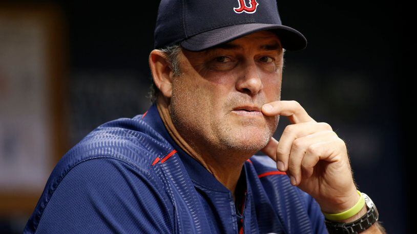 ST. PETERSBURG, FL - SEPTEMBER 15: Manager John Farrell #53 of the Boston Red Sox looks on from the dugout during the third inning of a game against the Tampa Bay Rays on September 15, 2017 at Tropicana Field in St. Petersburg, Florida. (Photo by Brian Blanco/Getty Images)