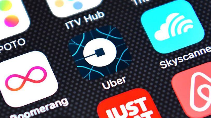 The Uber app logo is displayed on an iPhone. The ride-sharing service is exploring a new app feature that would allow a driver to tell if a potential rider is drunk.