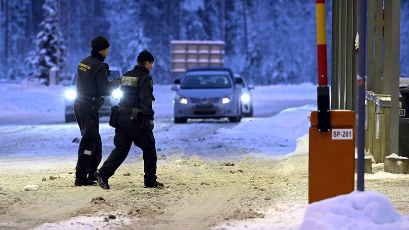 FILE - Finnish border guards walk at Vaalimaa border check point between Finland and Russia in Virolahti, Finland, on Dec. 15, 2023. Finland will extend the closure of its border crossing points with Russia beyond the current April 14 deadline “until further notice” due to a high risk of organized migration orchestrated by Moscow, the Finnish government said on Thursday, April 4, 2024. (Heikki Saukkomaa/Lehtikuva via AP)