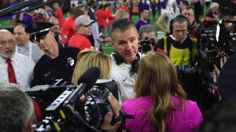 Ohio State’s Urban Meyer talks to a reporter as the Buckeyes celebrate a victory over Northwestern in the Big Ten Championship on Saturday, Dec. 1, 2018, at Lucas Oil Stadium in Indianapolis.
