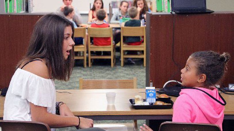 Centerville High School students spend lunch time with Cline Elementary students as part of the “Lunch Buddies” program. Centerville City Schools’ state funding would follow an odd pattern if Gov. John Kasich’s budget plan became law. CONTRIBUTED PHOTO