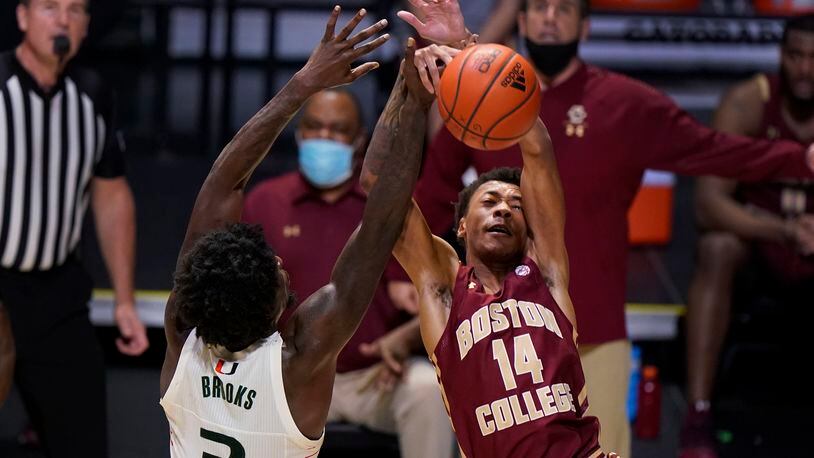 Miami center Nysier Brooks (3) blocks a shot by Boston College forward Kamari Williams (14) during the first half of an NCAA college basketball game, Friday, March 5, 2021, in Coral Gables, Fla. (AP Photo/Wilfredo Lee)