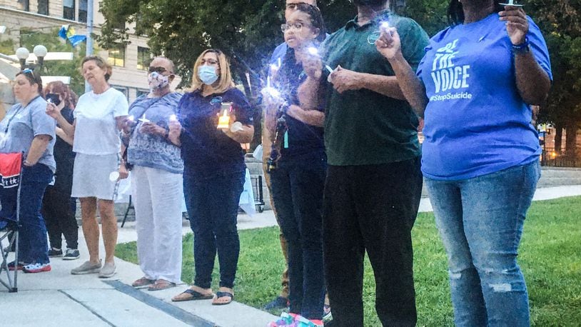 A candlelight vigil was held in Dayton Tuesday night September 7, 2021 to remember, honor and cherish lives lost to suicide. PARKER PERRY/STAFF