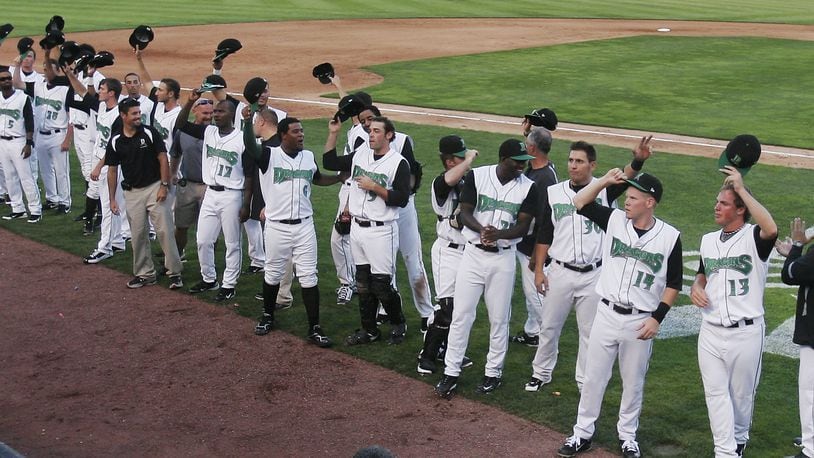 The Dayton Dragons tip their hats to the fans at Fifth Third Field Saturday July 9, 2011, after earning 815th consecutive sellout. STAFF PHOTO BY JIM NOELKER