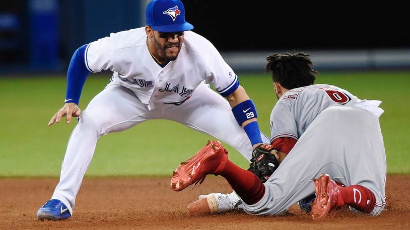 Cincinnati Reds’ Billy Hamilton (6) steals second base safely as Toronto Blue Jays second baseman Devon Travis (29) applies the tag during the seventh inning of an interleague baseball game in Toronto on Tuesday, May 30, 2017. (Nathan Denette/The Canadian Press via AP)